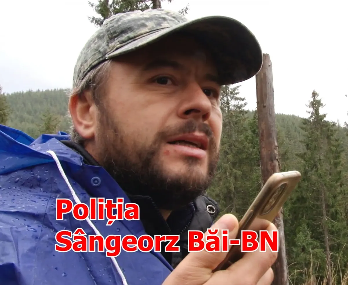 A man holding a phone in a video frame labelled “Poliția Sângeorz Băi-BN”.